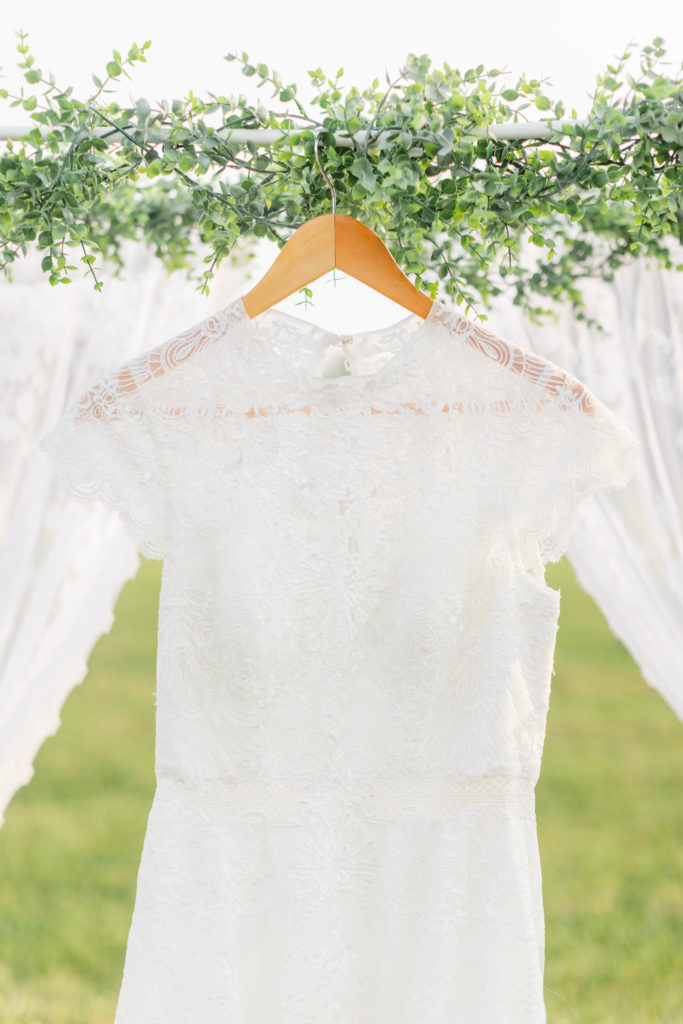 The bride's dress was a beautiful ivory color covered in lace. Intimate summer elopement.