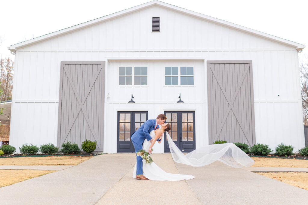 The bride and groom pose for their Simple & Classic Fall Wedding at white oak farms.