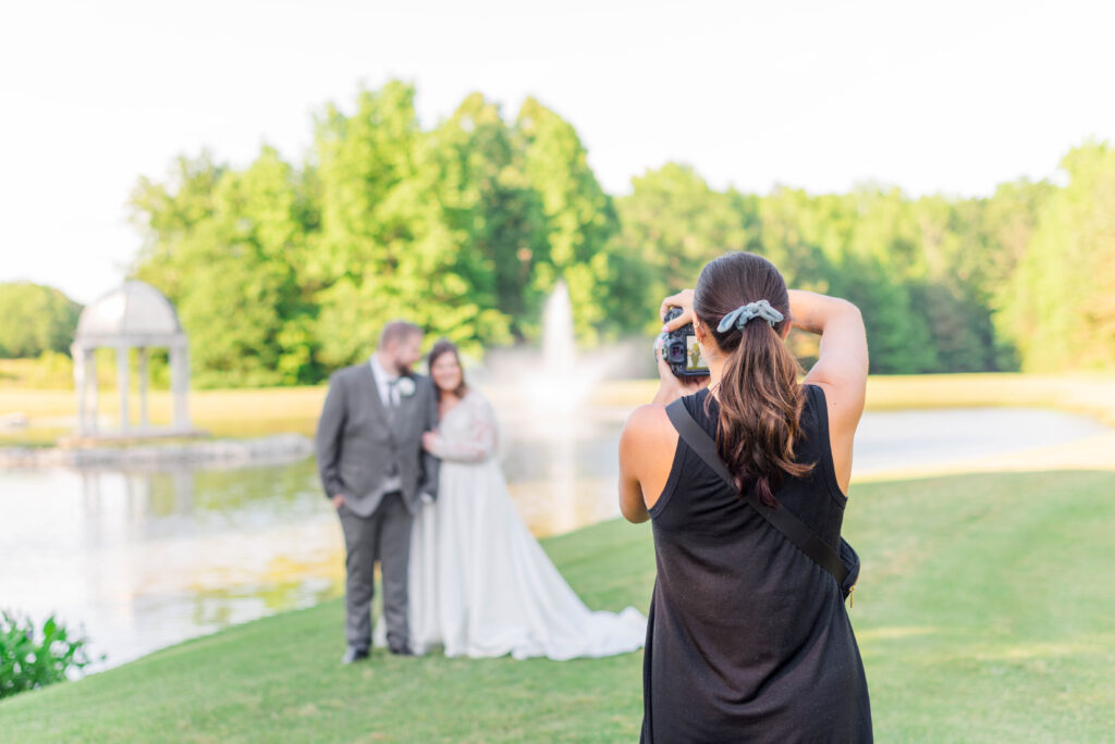 Wedding photographer in action taking a portrait of the bride and groom