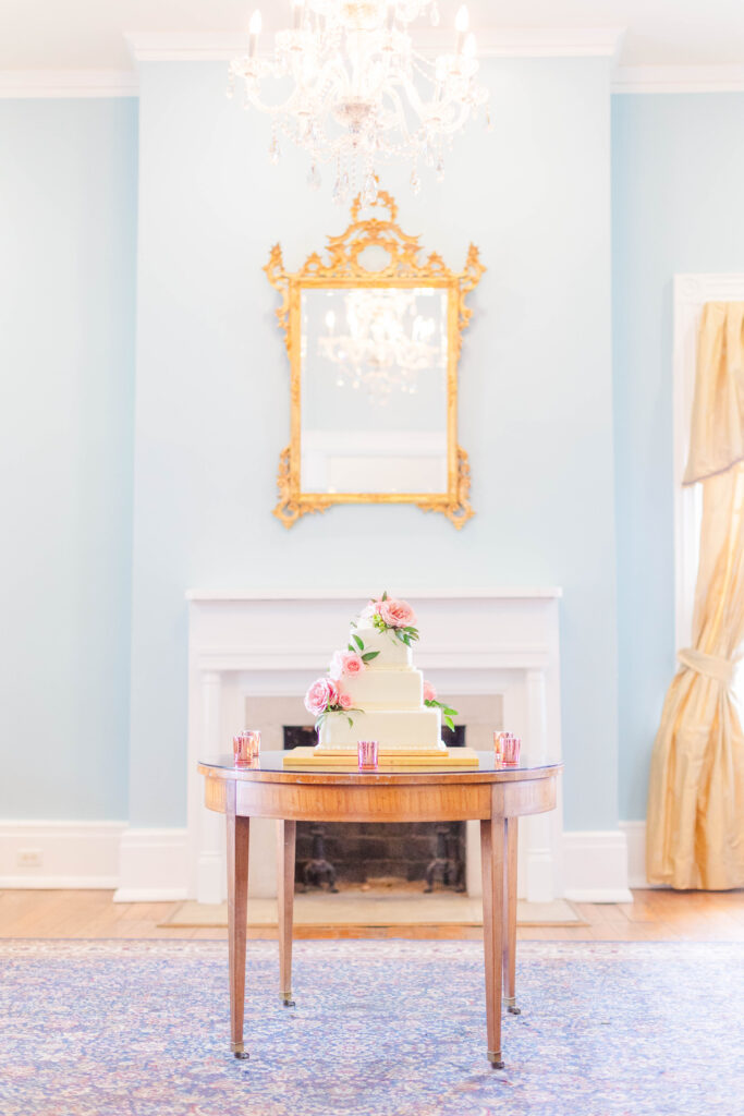 Ravenswood Mansion, historical wedding venue in Nashville has a beautiful blue room with gold accent pieces like the mirror over the fire place and the curtains.